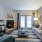 Spacious and well lit living room with wood floors and an open floor plan with access to the kitchen.