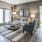 Spacious and well lit living room with wood floors and an open floor plan with access to the kitchen.
