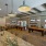 Large well lit game room with bar seating and two billiard tables 