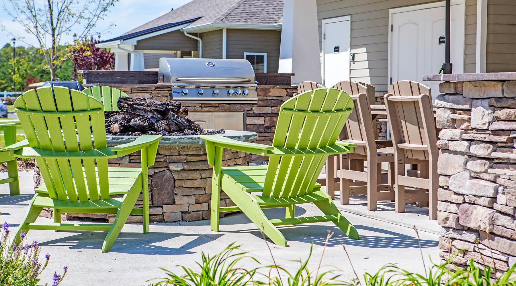 Large outdoor BBQ area with a fire pit and plenty of seating 