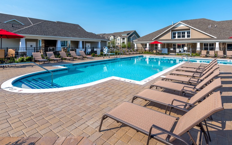 Large sparkling pool with sundecks and ample lounge chairs.