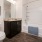Large well lit bathroom with wood floors and dark wood cabinets