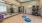 Large yoga room with a large window and weighted balls.