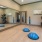 Large yoga room with a large window and weighted balls.