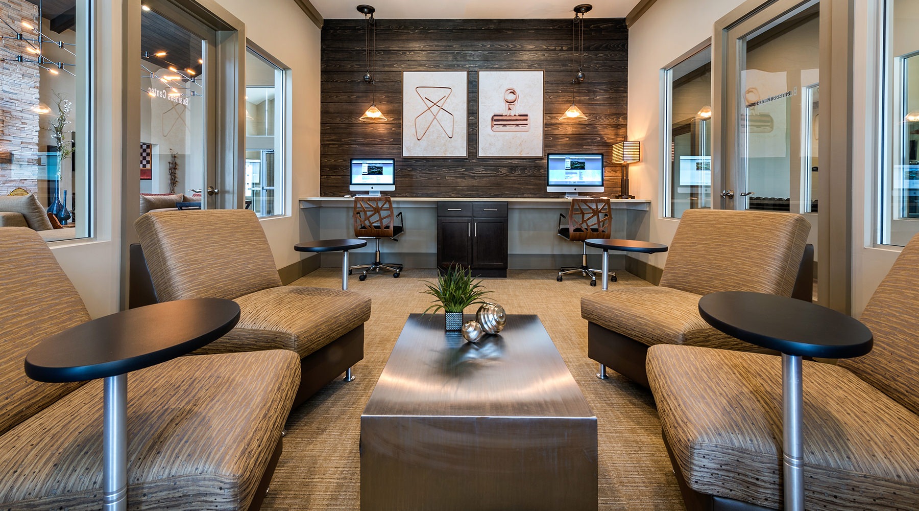 Spacious and well lit lobby with plenty of seating and large windows with a view of the city 