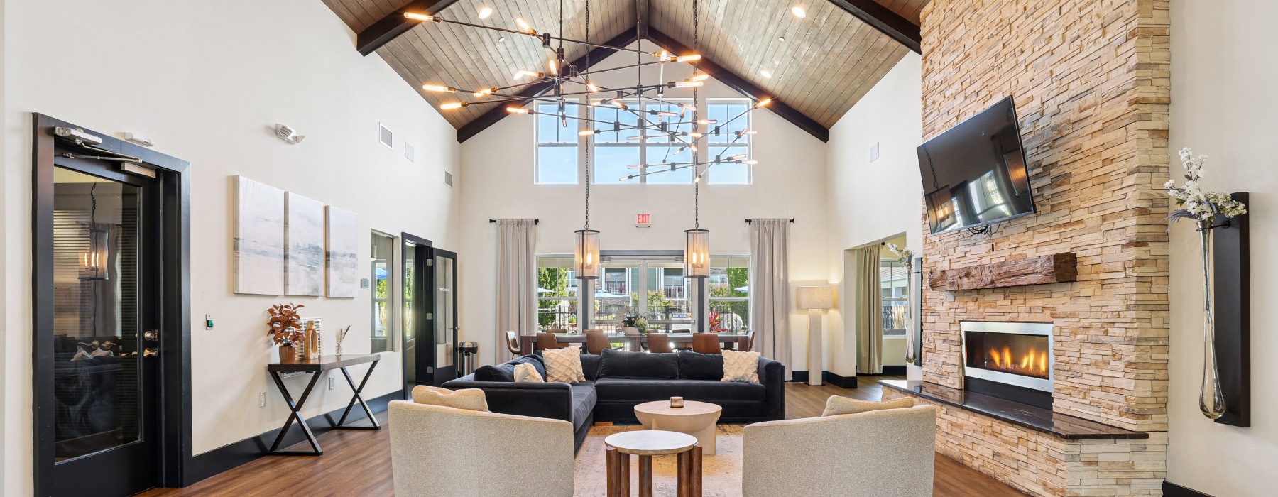 Lounge with chairs and couch with fireplace.